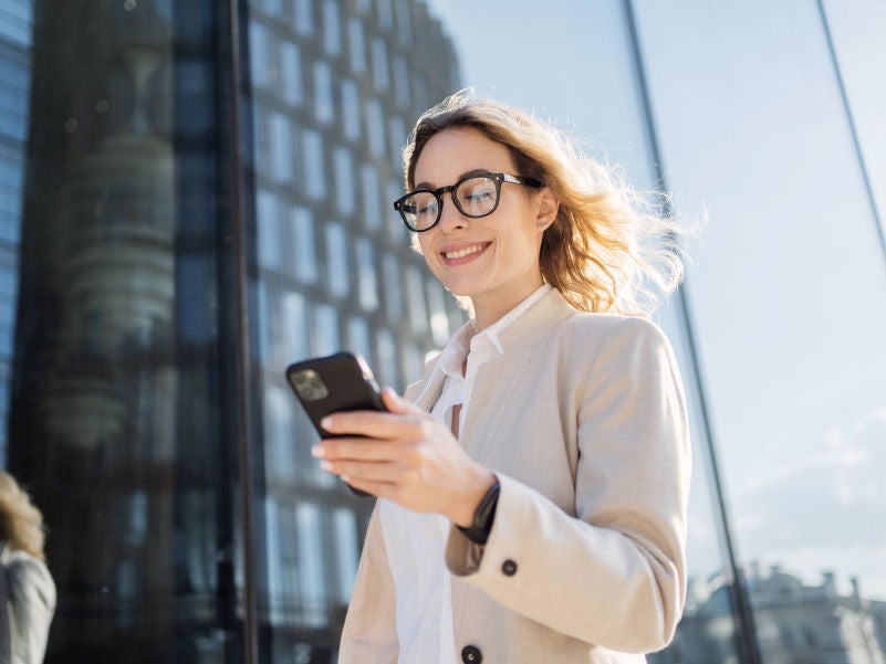 A business professional on a smartphone.