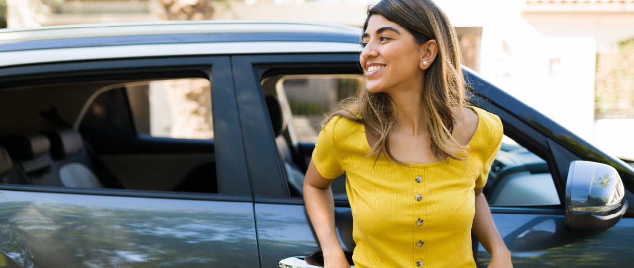Girl Standing in front of a car