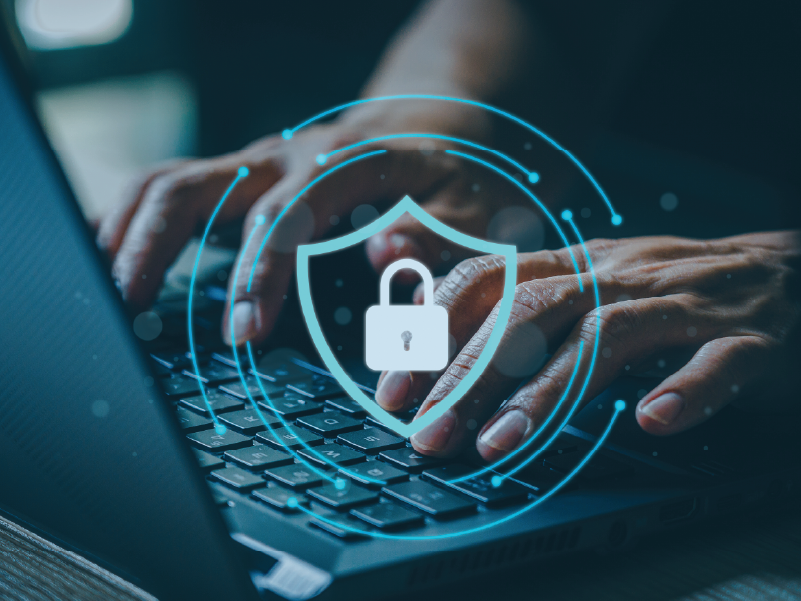 An image of hands typing on a laptop. An icon of a secure lock is laid over the image.