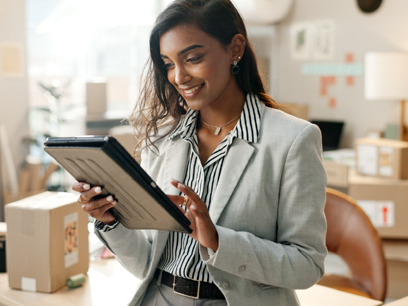 an image of a woman in a business suit using a tablet.