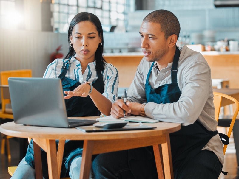 Small business owners reviewing things on a laptop.