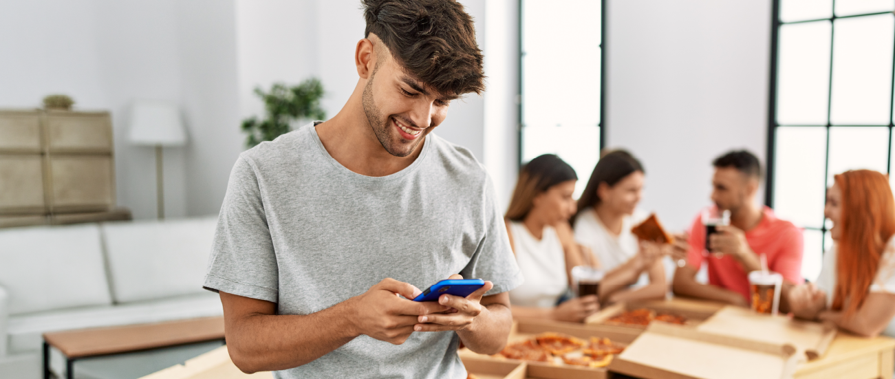 A young an making a payment on a smartphone.