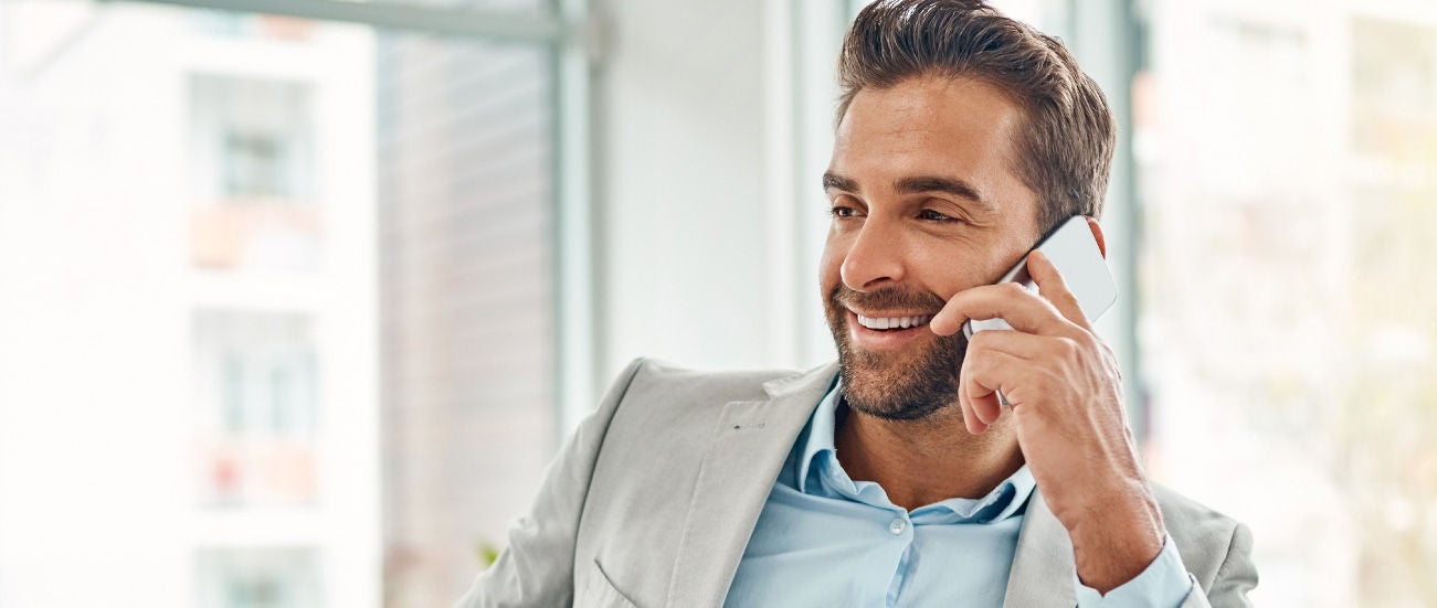 A business professional on a tablet and cell phone.