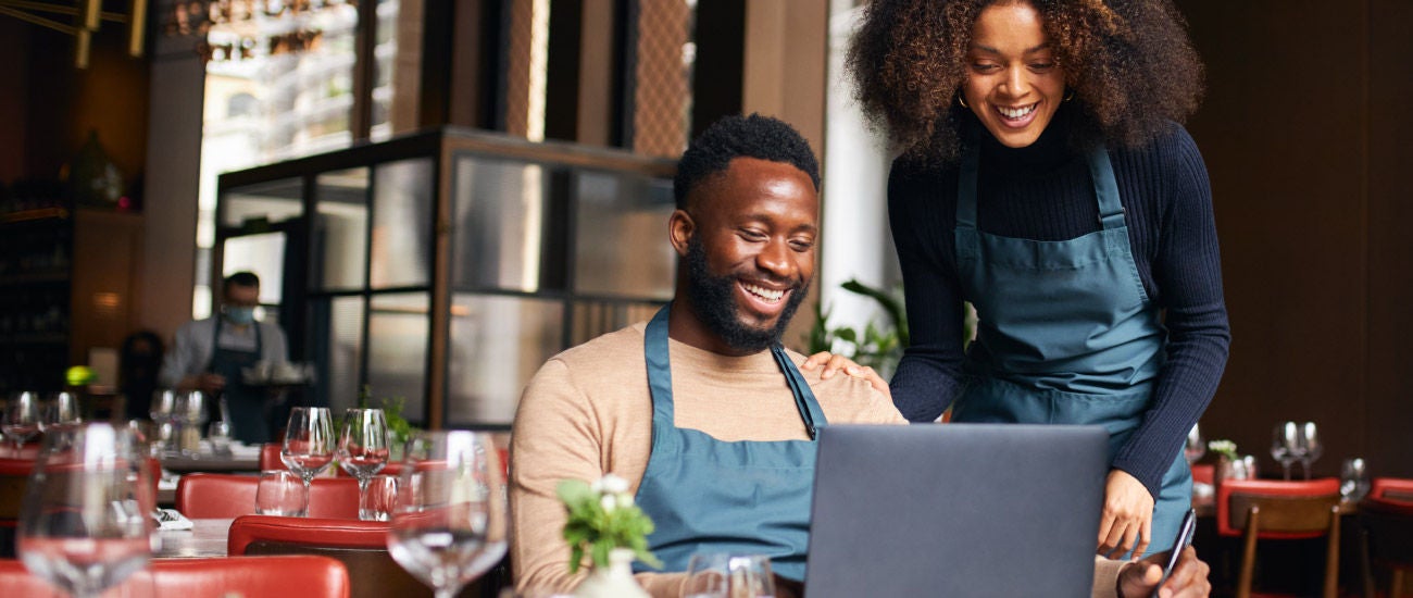 a man and woman in front of a computer