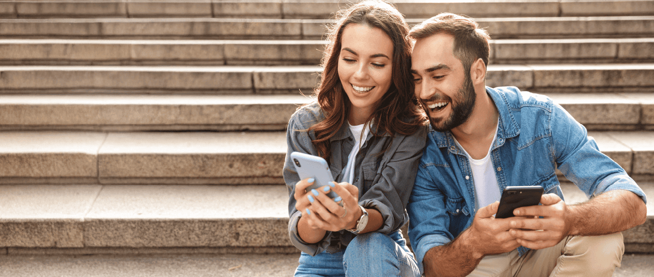 a man and woman on smartphones.