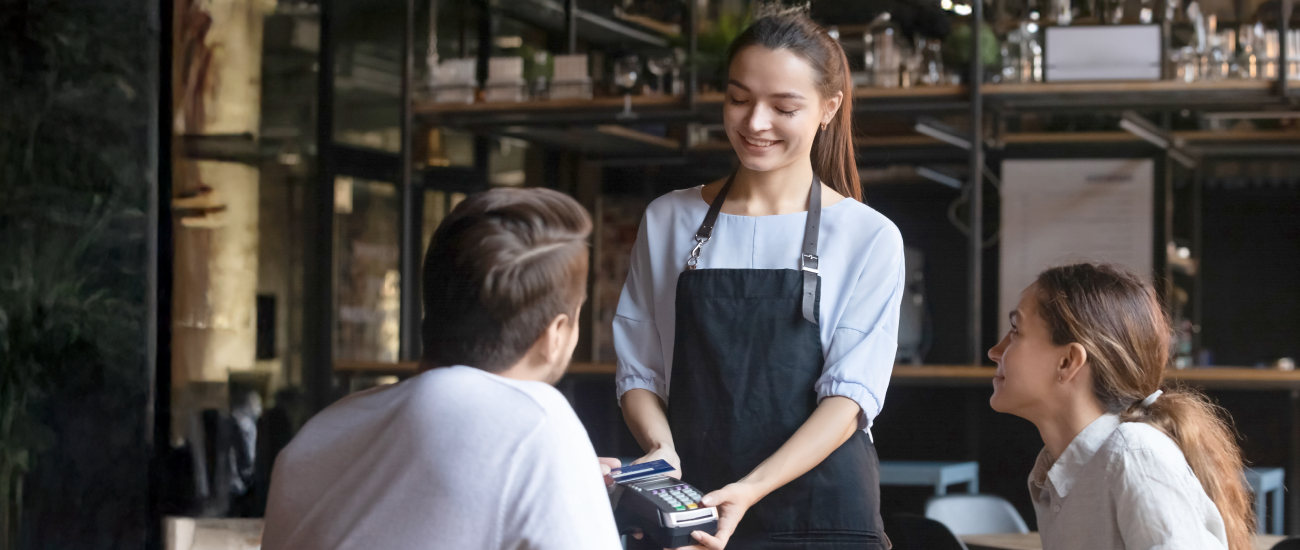 A woman holding a card reader.