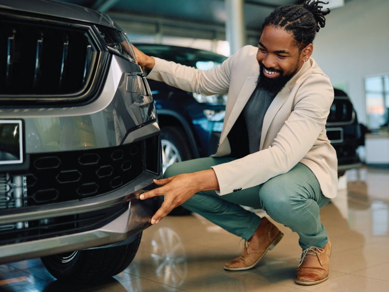Man looking at a car.