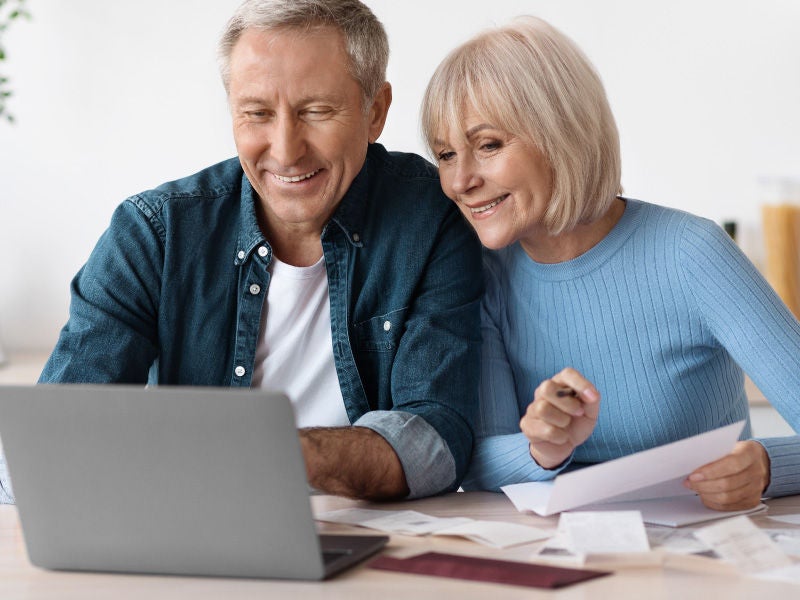 Two people on a laptop. 