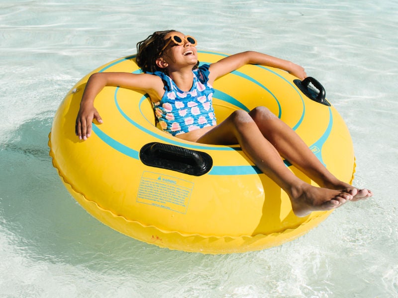 An image of a girl floating on an inner tube.