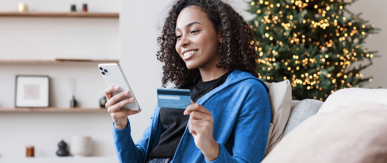 A woman holding a credit card.