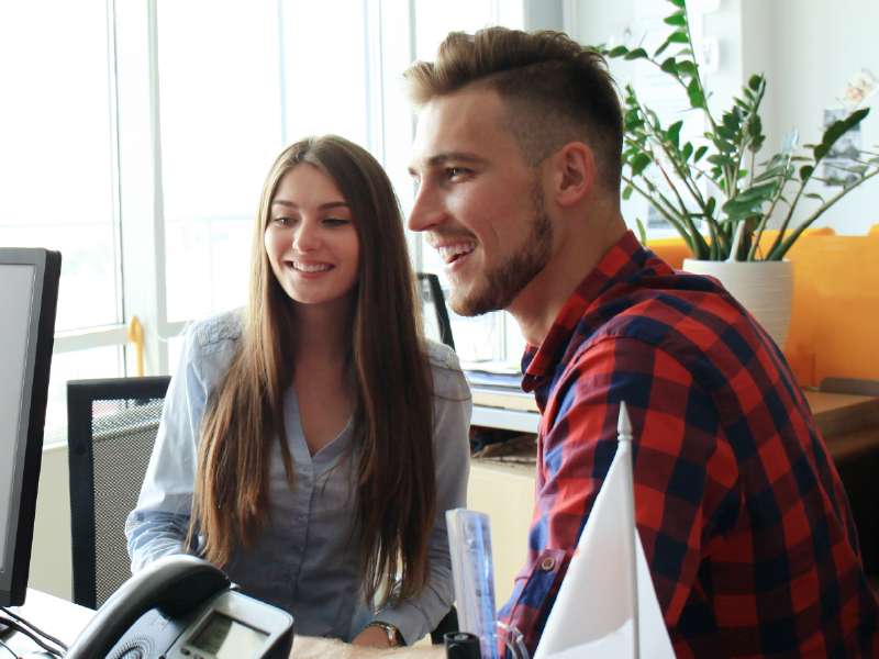 An image of a couple hving documents reviewed by a notary.