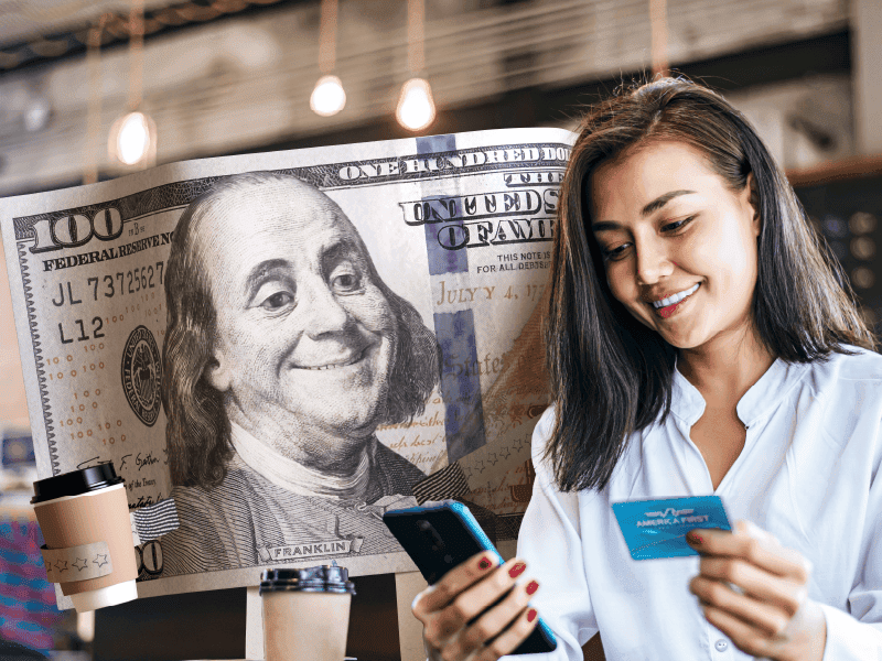 A woman buying coffee with her America First Credit Card.