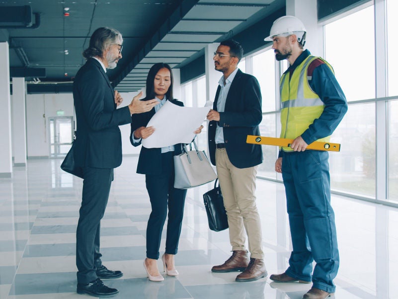 Four people inside a building
