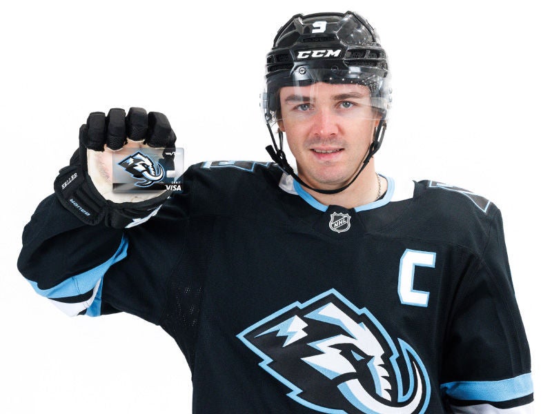 Mammoth player holding card. 