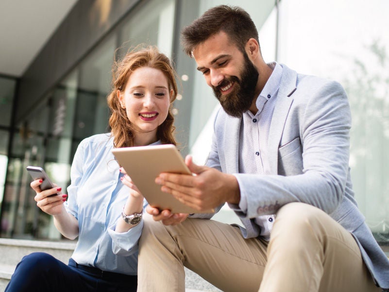 Two people looking at a tablet