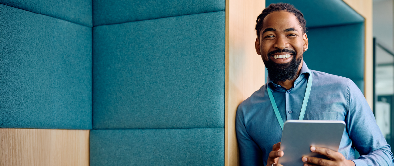  business professional holding a tablet and smiling.