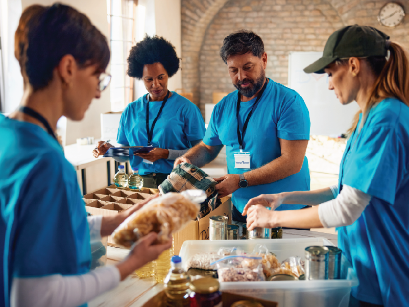 A group of volunteers packing food kits. 