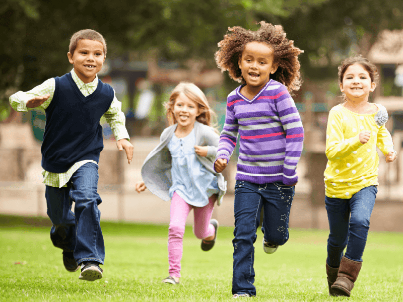 A group of children running and playing.