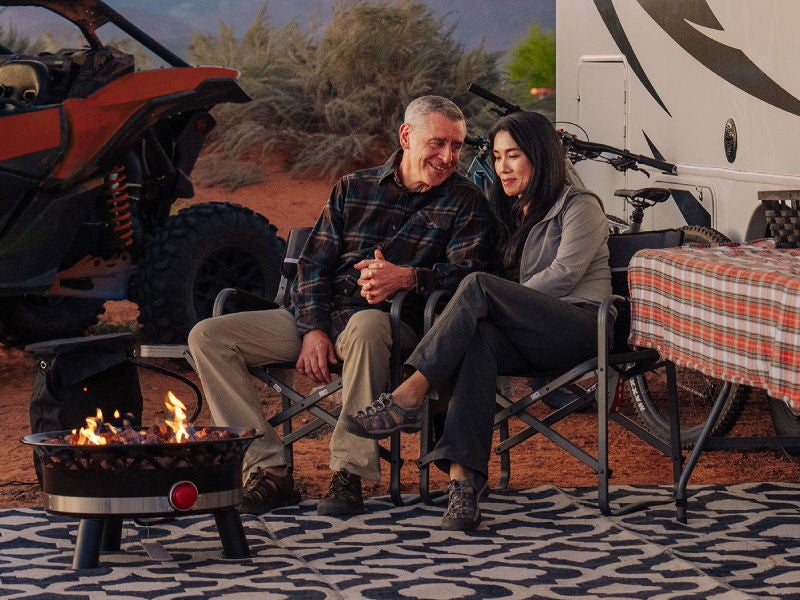 An image of a couple in front of an RV