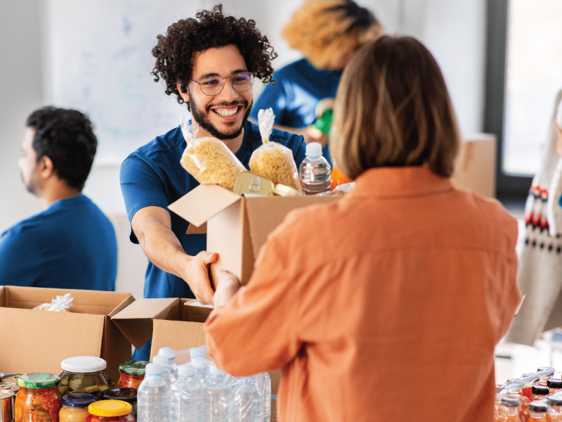 a man helping with a food drive