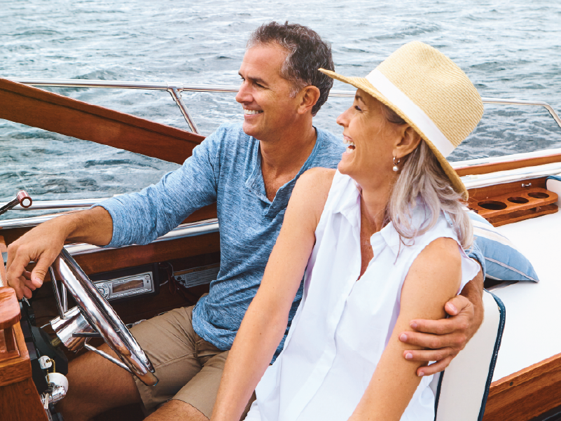 An image of a man and woman riding in a motor boat.