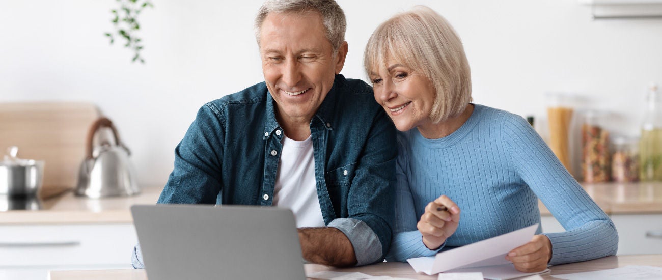 A man and woman on a computer.