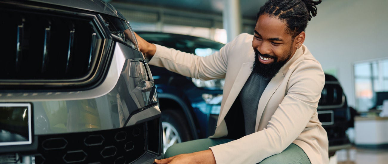 A man looking at a car