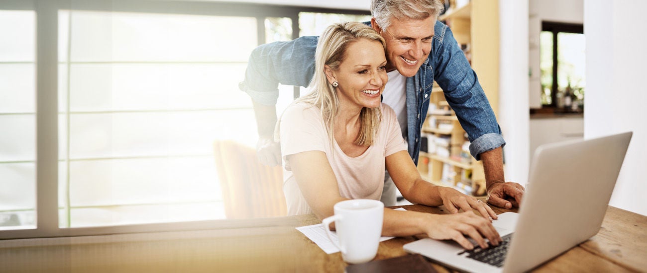 a man and woman in front of a computer
