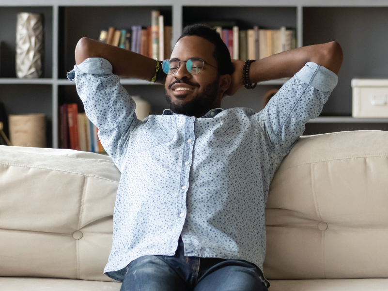 A man sitting on the couch relaxing. 
