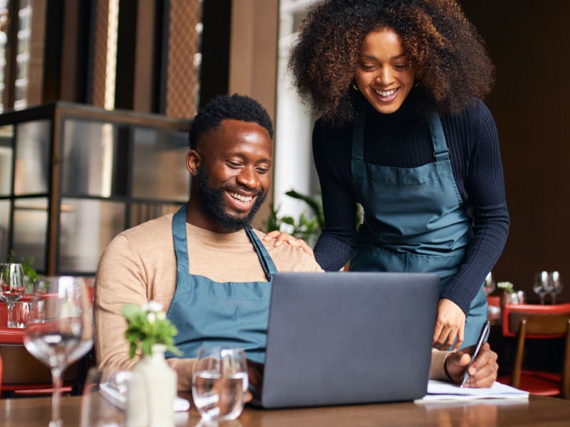 a man and woman in front of a computer